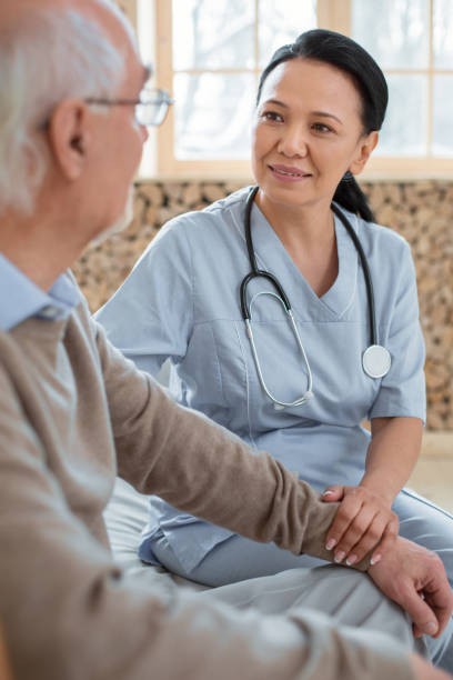 istock Glad doctor worrying about senior man 935366660