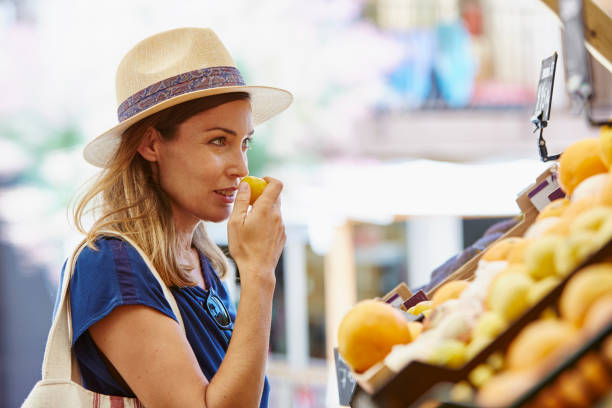 istock Mature woman buying fruit from store 935367012