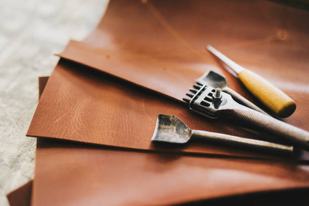 istock Crafting tools on natural cow leather in the tailoring workshop. Top view. 935367042