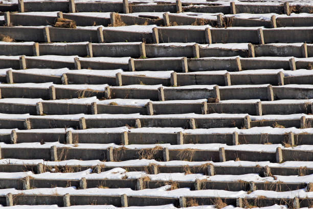 istock Rows of old concrete seats at abandoned stadium 935367224