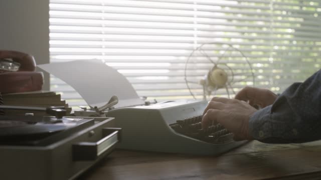 Man typing on a vintage typewriter