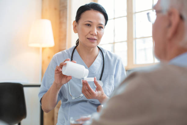 istock Worried doctor controlling senior mans pressure 935372470
