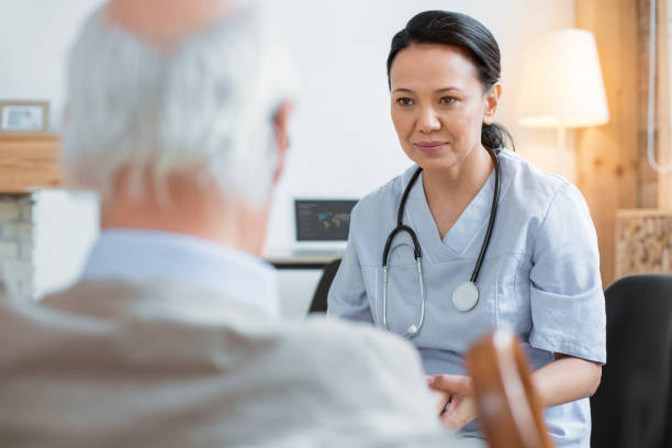 istock Attentive doctor curing senior man 935372868