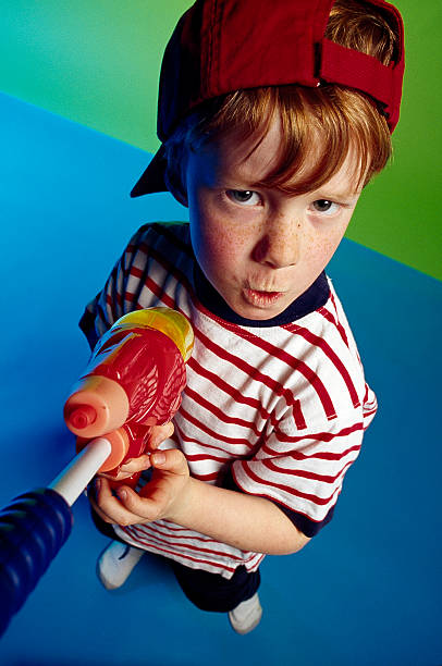 istock tough boy (7-11) holding a water gun 93539261