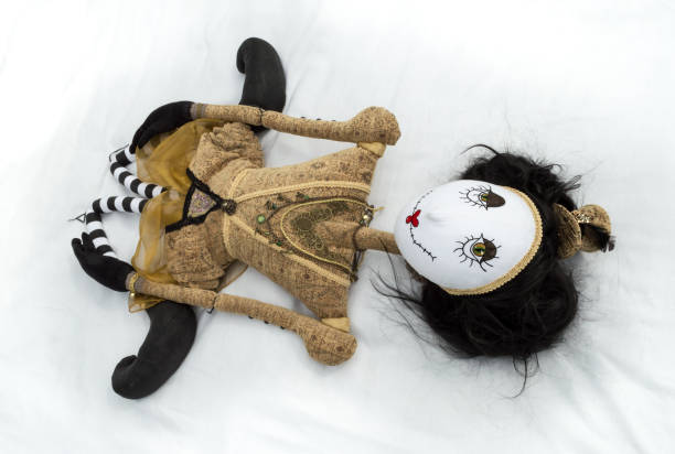 istock Creepy steampunk doll lying on back with legs tucked. 935394822