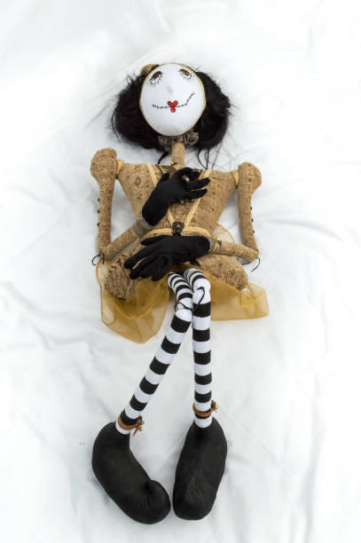 istock Creepy steampunk doll lying on back knees raised. Vertical. 935395108
