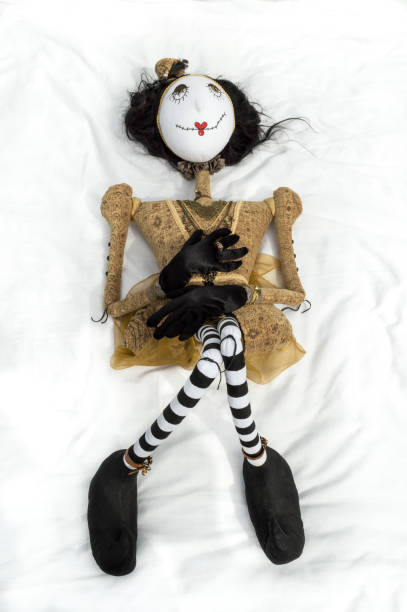 istock Creepy steampunk doll lying on back knees raised. Vertical. 935395222