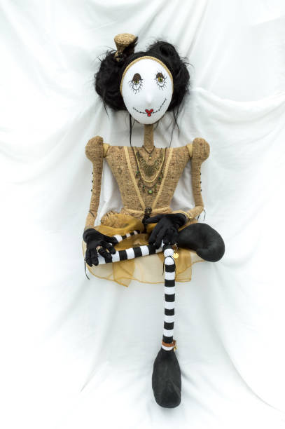 istock Creepy steampunk doll sitting facing forward. Leg crossed. Vertical. 935395614