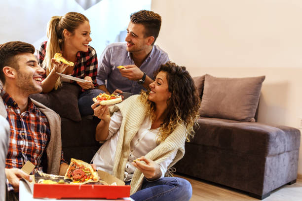 istock Group of young friends eating pizza. 935395806