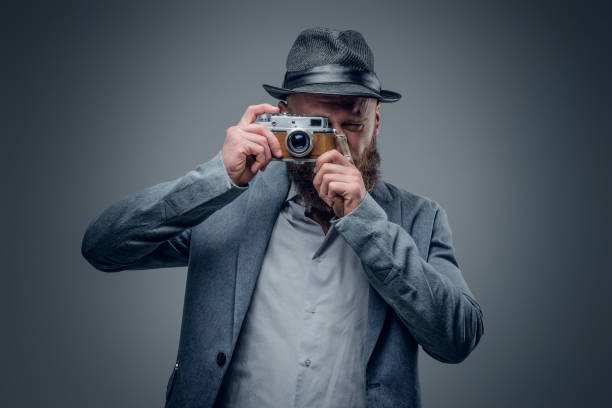istock A man shooting with the vintage SLR photo camera. 935395820