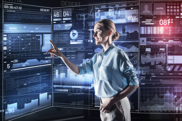 istock Positive woman smiling and pointing to the screen while working 935395926