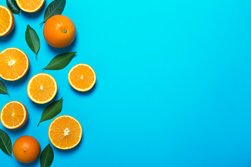 Fresh oranges on the blue background. Top view