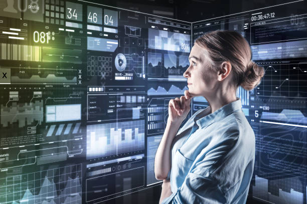 istock Smart woman touching her chin while thoughtfully looking at the screen 935396206