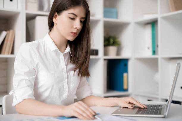 istock Thoughtful female manager working on report 935401036