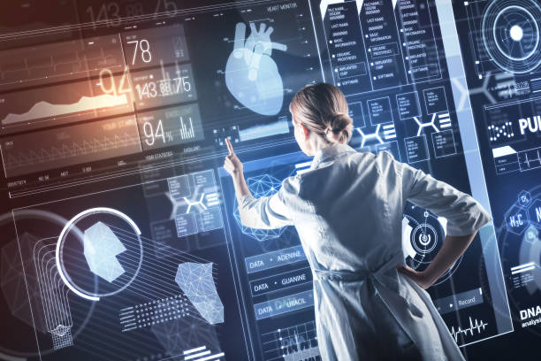 istock Attentive doctor pointing to the screen while working at her research 935401068