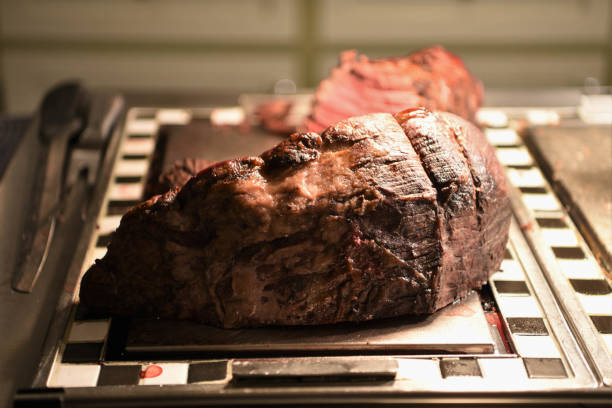 istock succulent and delicious cooked whole roast joint of beef in a kitchen 935401956