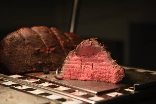 istock whole roast beef and a joint sliced to show the pink tender meat inside 935402296