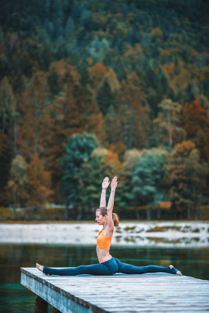istock Young woman doing yoga in nature 935402464