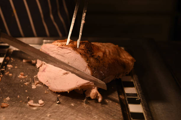 istock roast turkey meat being carved with fork and knife 935403192