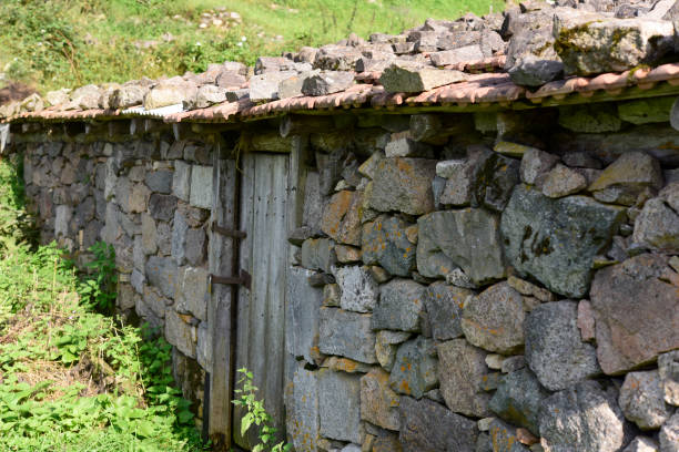 istock stone house with wooden door 935403704