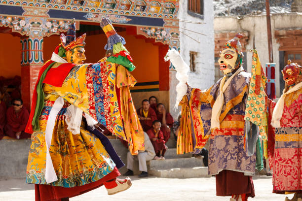 Unidentified monks perform a religious masked and costumed mystery dance of Tibetan Buddhism  at the traditional Cham Dance Festival. Lamayuru, India - June 16, 2012: unidentified monks perform a religious masked and costumed mystery dance of Tibetan Buddhism  at the traditional Cham Dance Festival. cham mask stock pictures, royalty-free photos & images