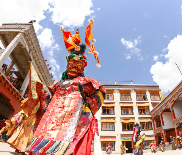 Unidentified monks perform a religious masked and costumed mystery dance of Tibetan Buddhism at the traditional Cham Dance Festival in Lamayuru monastery. stock photo
