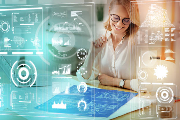 istock Optimistic engineer looking at the blueprint and feeling satisfied with it 935404524