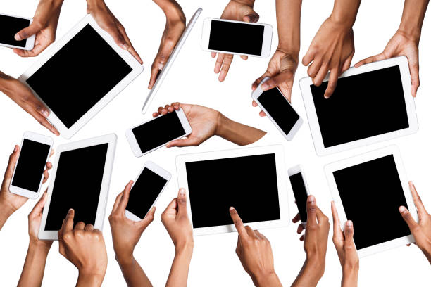 istock Black male hands pointing, holding mobile phone and tablet 935404792