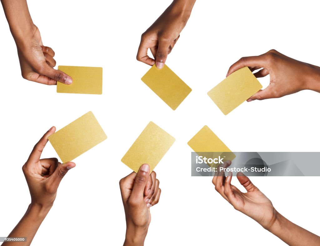 Black male hand with golden business cards. Set, isolated on white. Set of african-american man's hands holding golden empty business or credit cards with copy space. Isolated at white background Playing Card Stock Photo