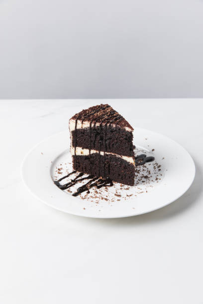 istock Front view of chocolate cake with glaze on plate placed on white surface 935406458