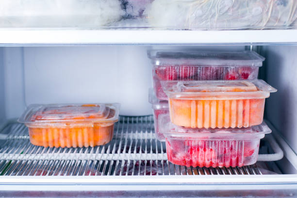 istock Frozen fruits and berries in a container in the freezer 935411154