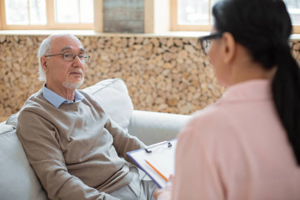 istock Caregiver making contact with pensive senior man 935412054
