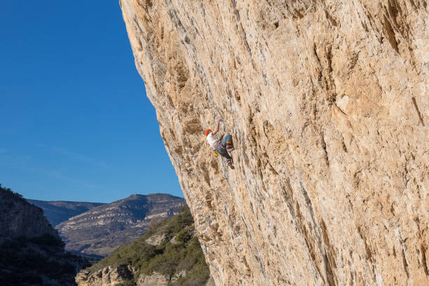 A Japanese woman enjoying free climbing under the blue sky its wonderful landscape.