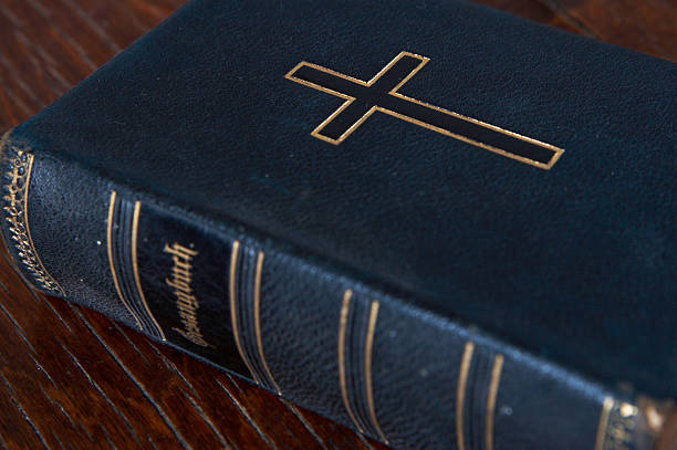 The bible on a wooden table stock photo