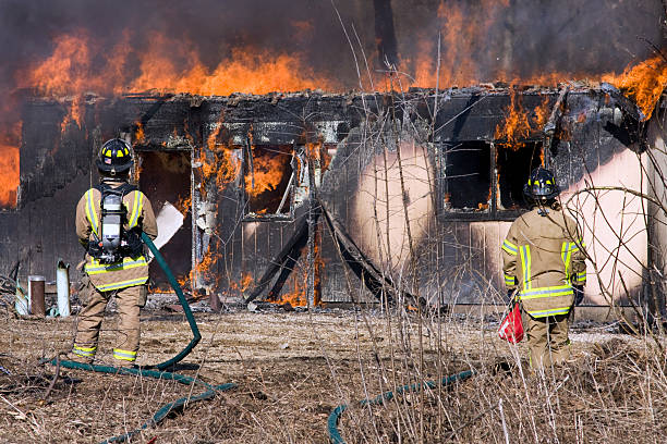 istock Firefighters standing in front of a burning house 93542183