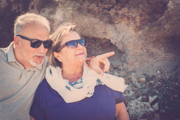 istock senior couple sit down on the bench 935428932