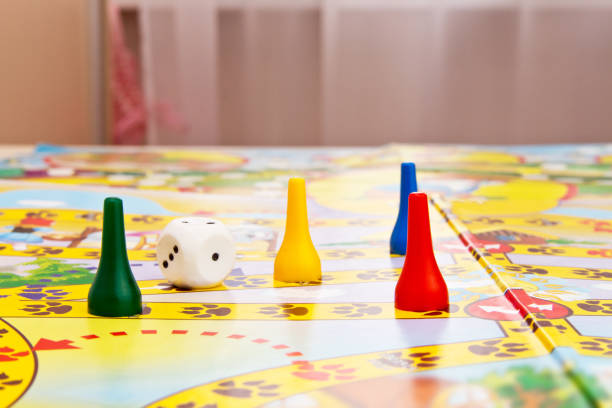 giochi da tavolo per la casa. chip e dadi di plastica gialli, verdi e rossi sui giochi da tavolo per bambini. messa a fuoco selettiva - circle child preschool preschooler foto e immagini stock