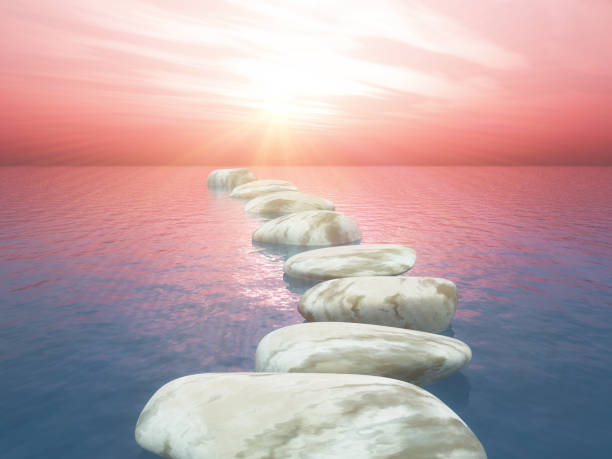 istock 3D stepping stones in ocean against sunset sky 935431642