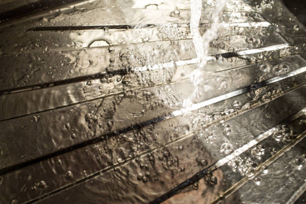 istock Drops of water falling on silver surface, sink in kitchen 935432346