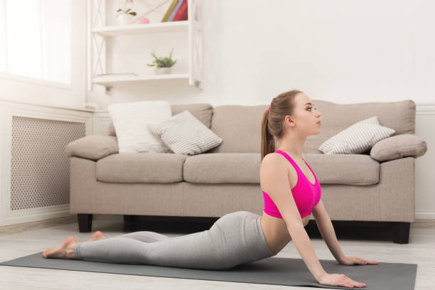 istock Woman training yoga in cobra pose. 935432444