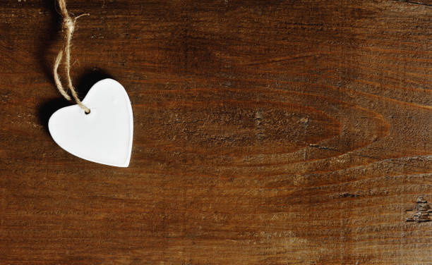 istock white heart on a vintage wooden background 935432462