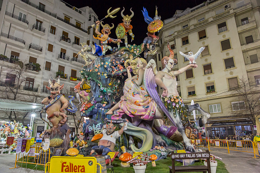 View of a Falla during Las Fallas Festival on March 18, 2018 in Valencia, Spain. The Fallas is Valencias most international festival, which runs from March 15 until March 19 and celebrates the arrival of spring with fireworks, fiestas and bonfires made by large puppets named Ninots. During the months preceding this unique festivity, a lot of hard work and dedication is put into preparing the monumental and ephemeral cardboard statues that will be devoured by the flames. The festival has been designated as a UNESCO Intangible Cultural Heritage of Humanity since 2017. The teme of this falla is about fable and nature. People look the falla.