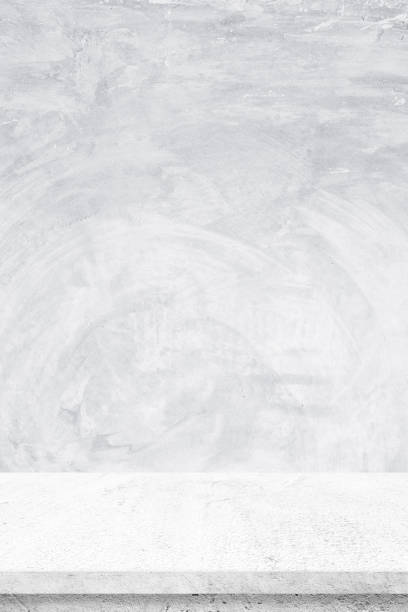 istock Empty white cement table over gray cement wall background, banner, table top, shelf, counter design for product display montage 935437880