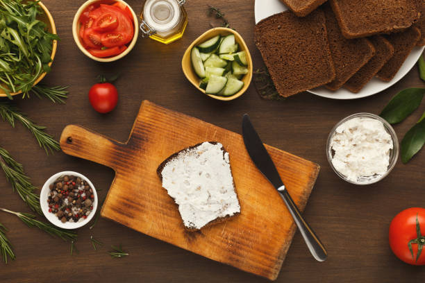 istock Cooking tasty sandwich with cream cheese, top view 935444804