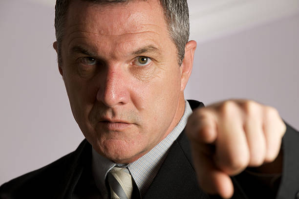 istock Businessman looking seriously at a person seated 93545367
