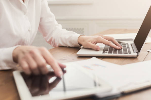 istock Woman hands on keyboard and tablet close up 935470764