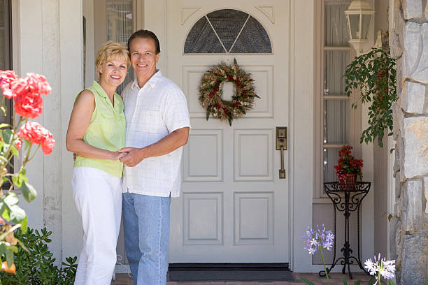 istock Couple Standing Outside Their House 93547189