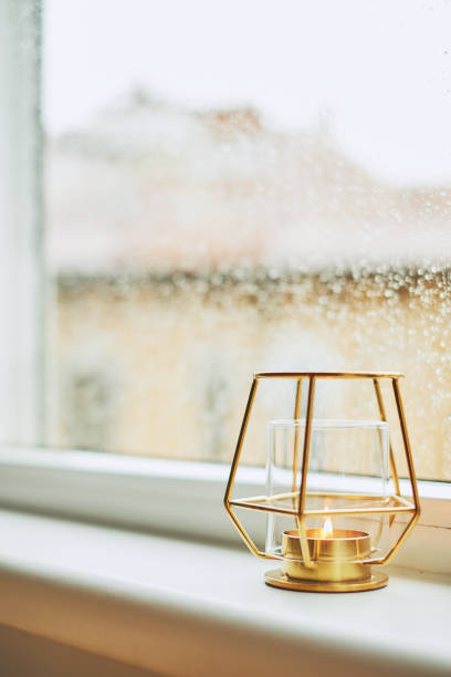 istock Golden candlestick holder by the window 935475332