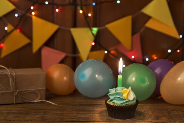 istock Chocolate cupcake with candle against festive background 935475768