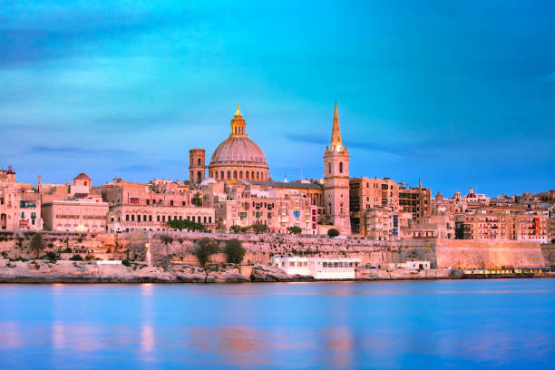 Valletta Skyline at beautiful sunset from Sliema with churches of Our Lady of Mount Carmel and St. Paul's Anglican Pro-Cathedral, Valletta, Capital city of Malta